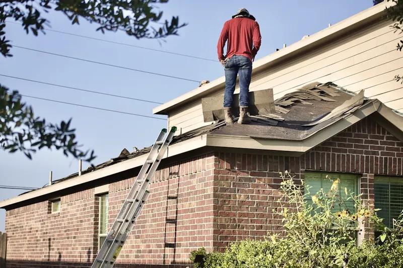 Professional roofer working on a residential roof in Kerwood